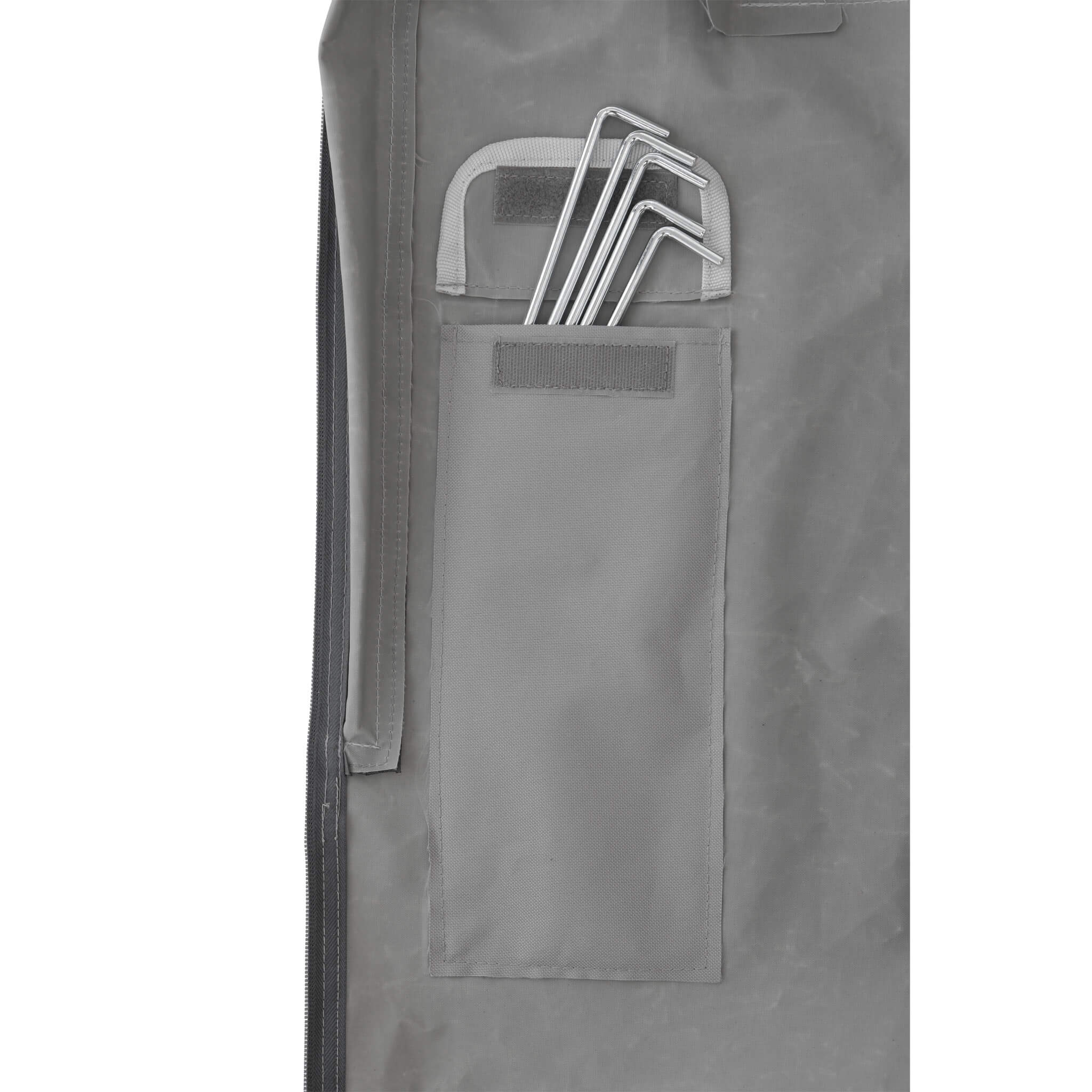 Close-up of CORE 10x10 center push canopy stake storage pocket in gray fabric with metal stakes neatly secured inside for easy access.