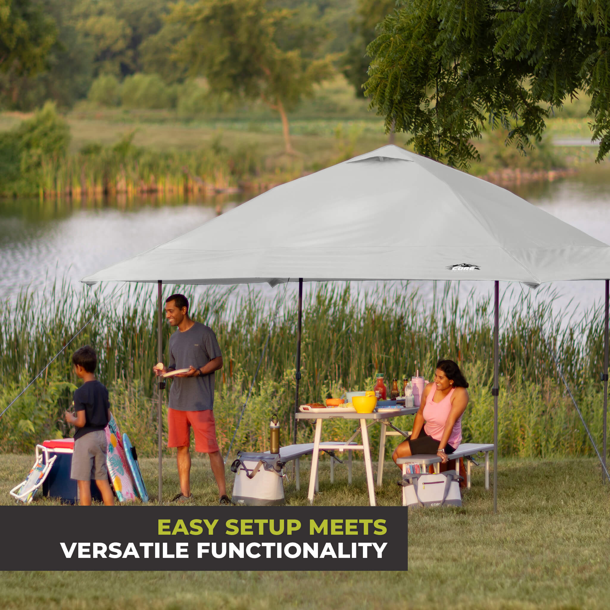 Family relaxing outdoors under the CORE 13x13 Center Push canopy top in gray, providing shade and ventilation for gatherings.