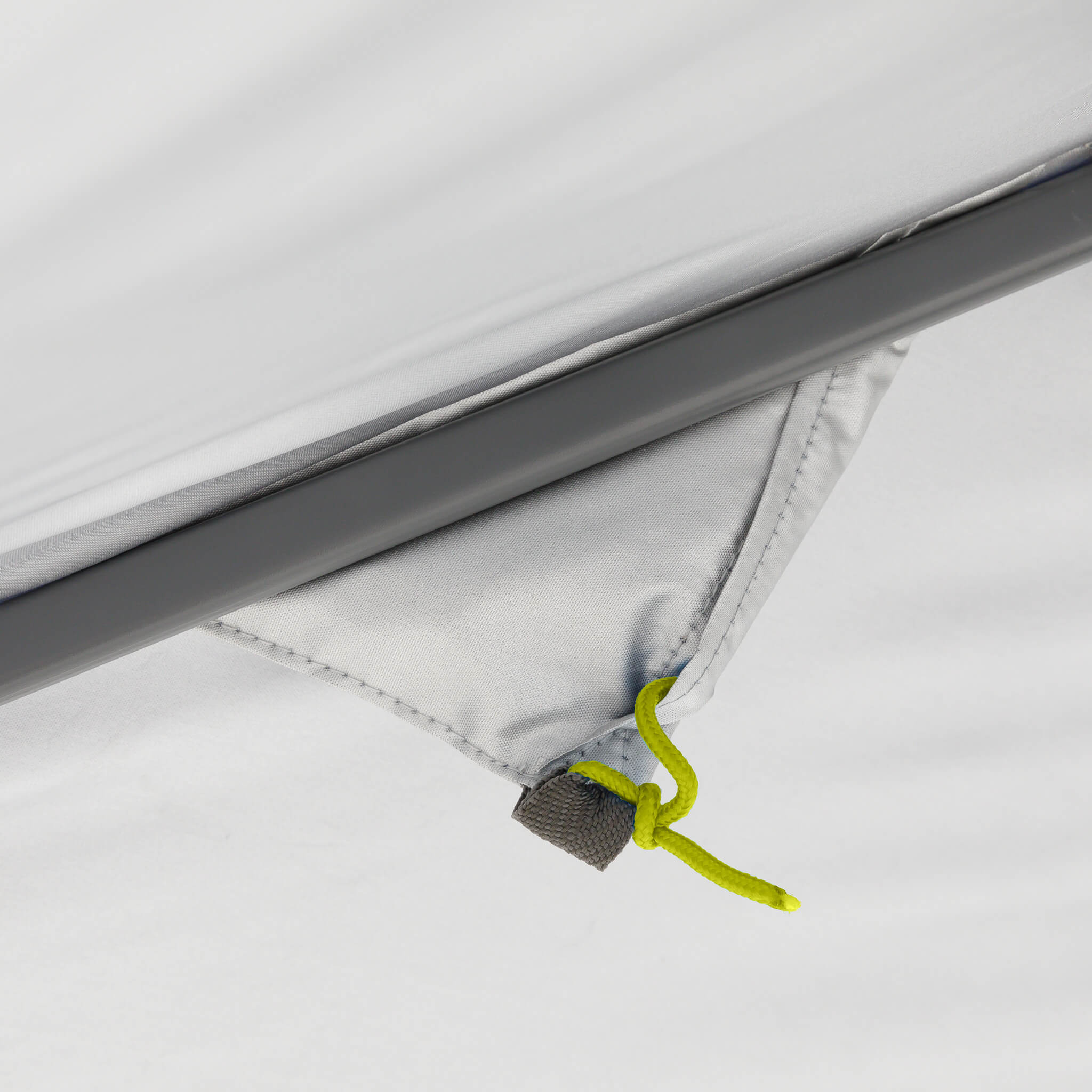 Close-up of CORE canopy guyline storage pocket with green cord, designed for secure tie-down and easy setup outdoors.