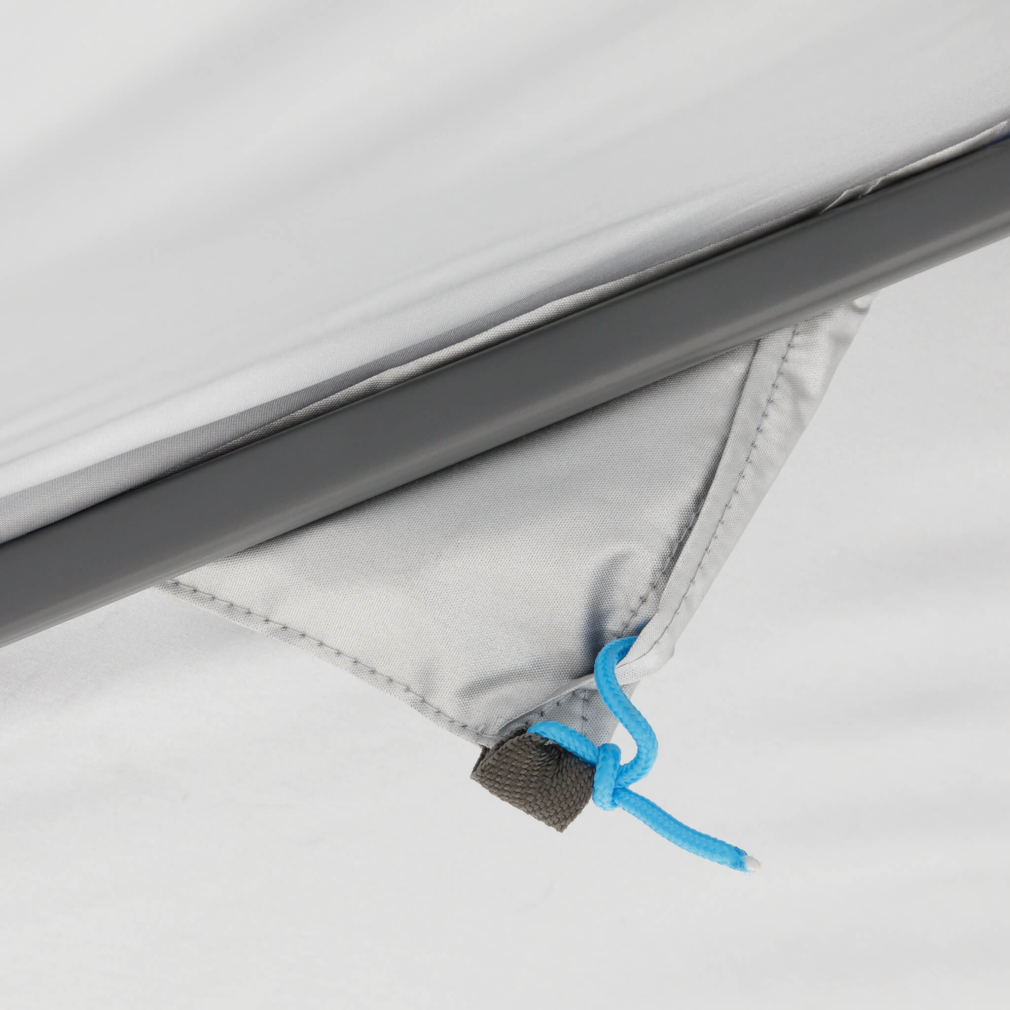 Close-up of CORE canopy guyline storage pocket with blue cord, designed for secure tie-down and easy setup outdoors.