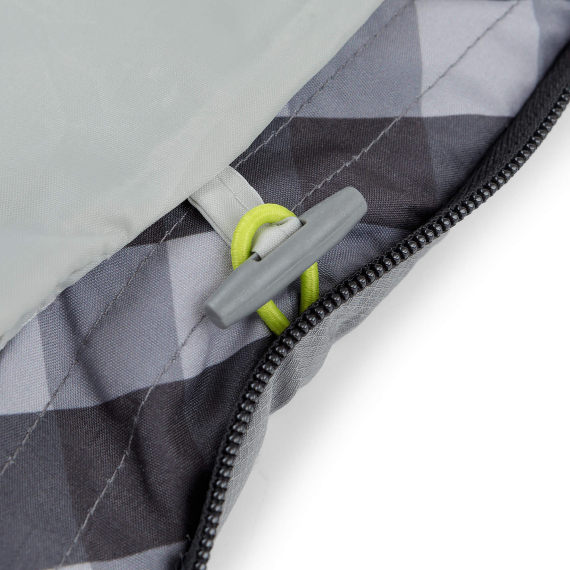 Close-up of a zipper with a gray pull tab on a CORE sleeping bag.