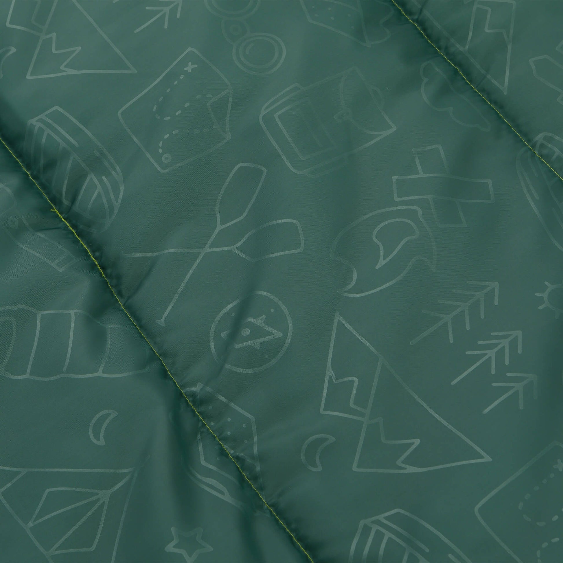 Close-up of green CORE Youth sleeping bag fabric with fun printed galaxy pattern.