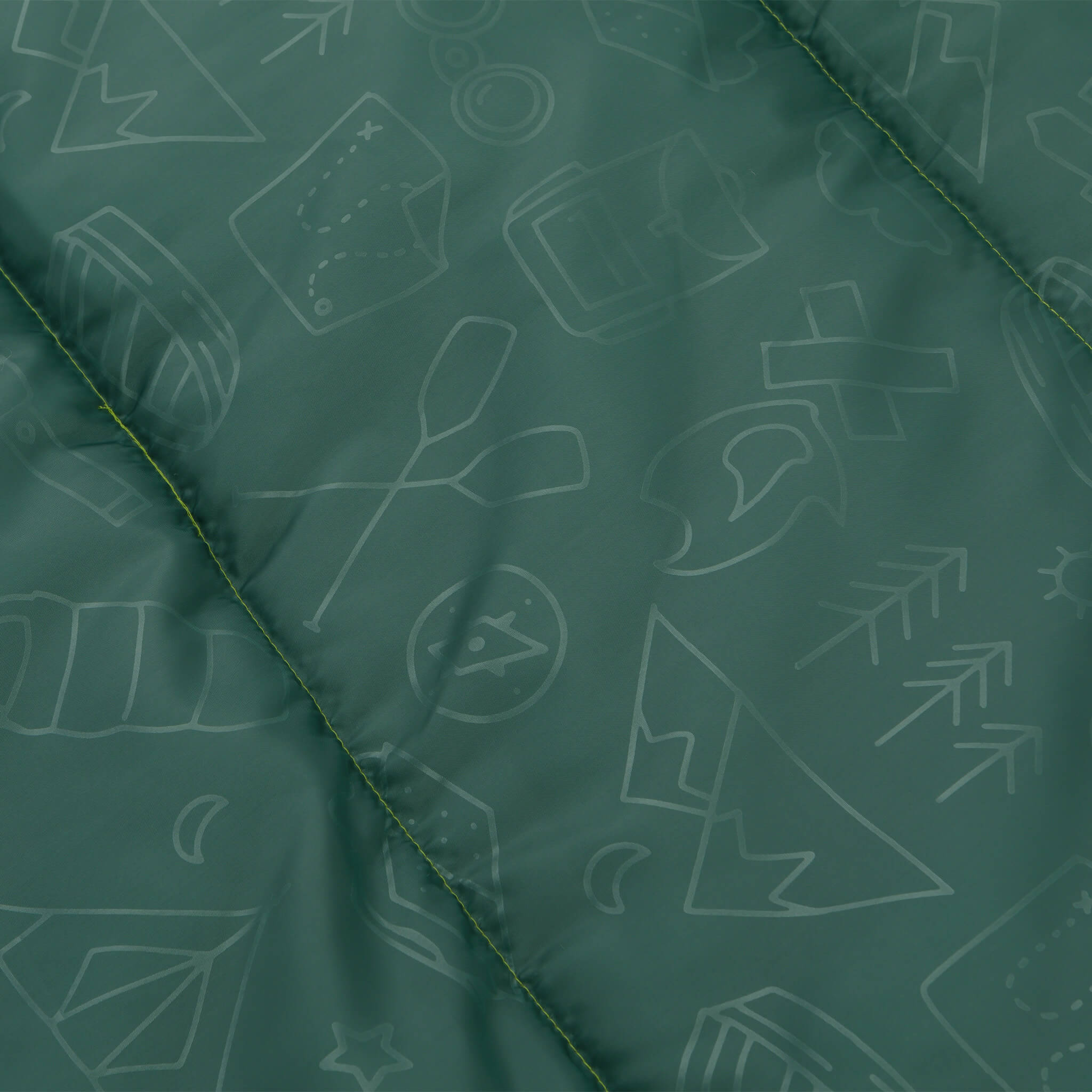 Close-up of green CORE Youth sleeping bag fabric with fun printed galaxy pattern.