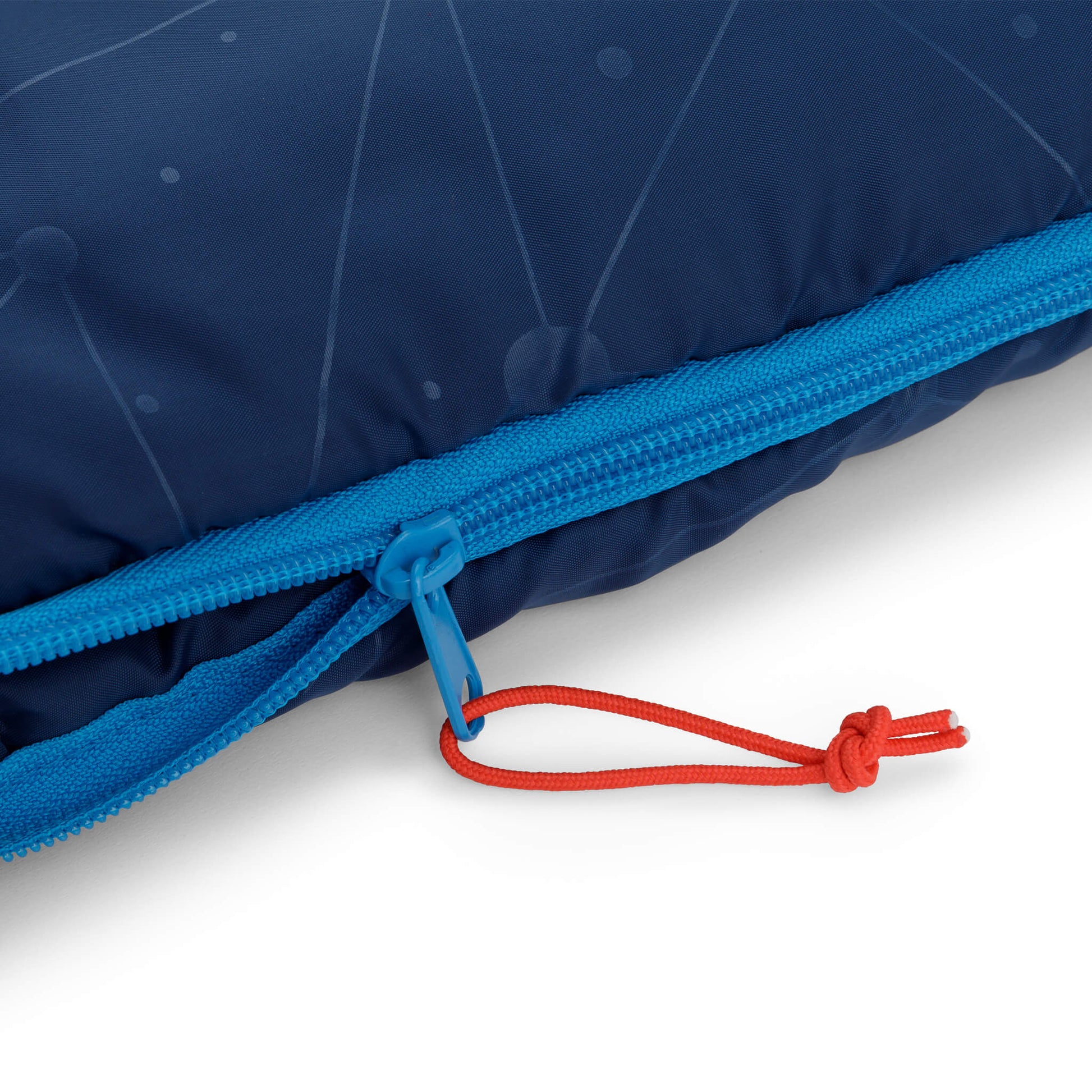 Close-up of blue CORE Youth sleeping bag zipper with red pull cord.