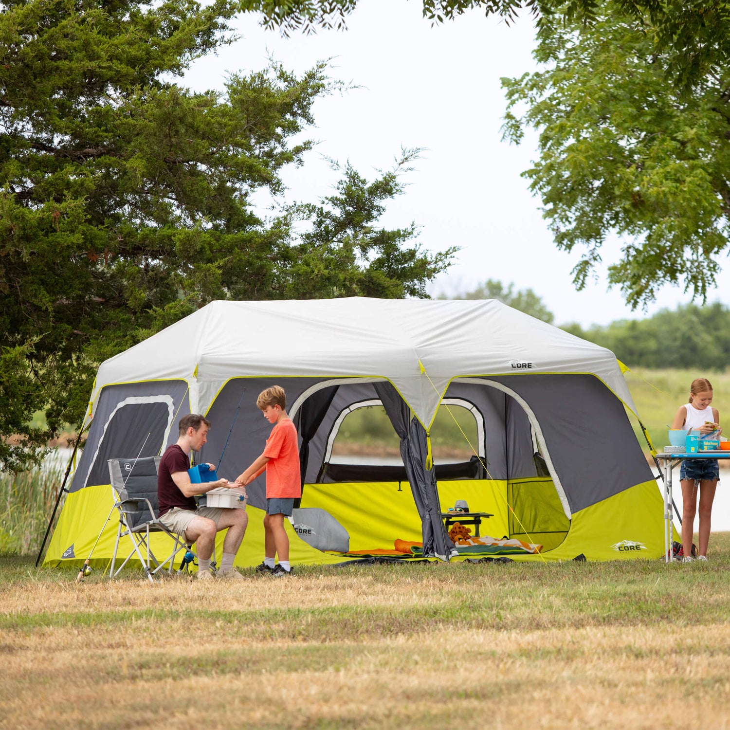 A family in front of a CORE 10 Person Instant Cabin Tent