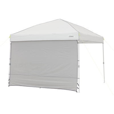 The 10' x 10' Sun Wall Accessory from CORE consists of a gray canopy tent with a triangular roof and a single gray sidewall. The sidewall extends from the top to the ground, providing shade and privacy. The canopy structure is supported by four legs, with ropes attached to the corners for stability.