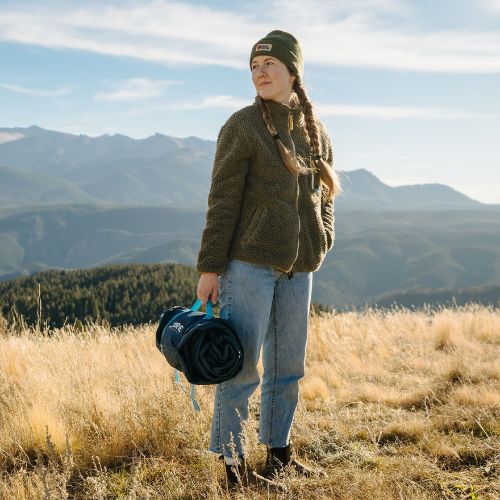 CORE Staydown™ Multipurpose Blanket rolled up with integrated carry handle and compression straps for easy transport and storage.