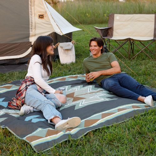 Oversized CORE Staydown™ Multipurpose Blanket providing plenty of room for two people to relax, picnic, and enjoy the outdoors.