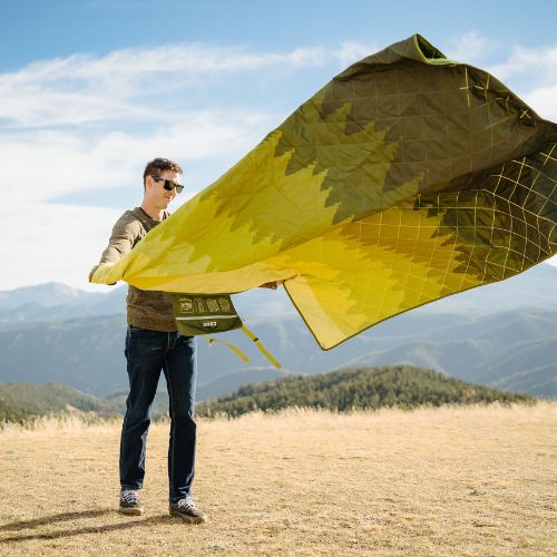 CORE Staydown™ Multipurpose Blanket demonstrating AnchorTech™ Technology, with weighted edges helping keep the blanket grounded in windy outdoor conditions.
