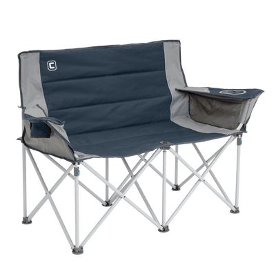 A portable double camping chair with a navy blue seat and backrest, light grey edges, and a sturdy light gray frame. The chair includes a drink holder on both armrests. Perfect for outdoor use, it's designed to accommodate two people comfortably while relaxing by the tent or campfire.