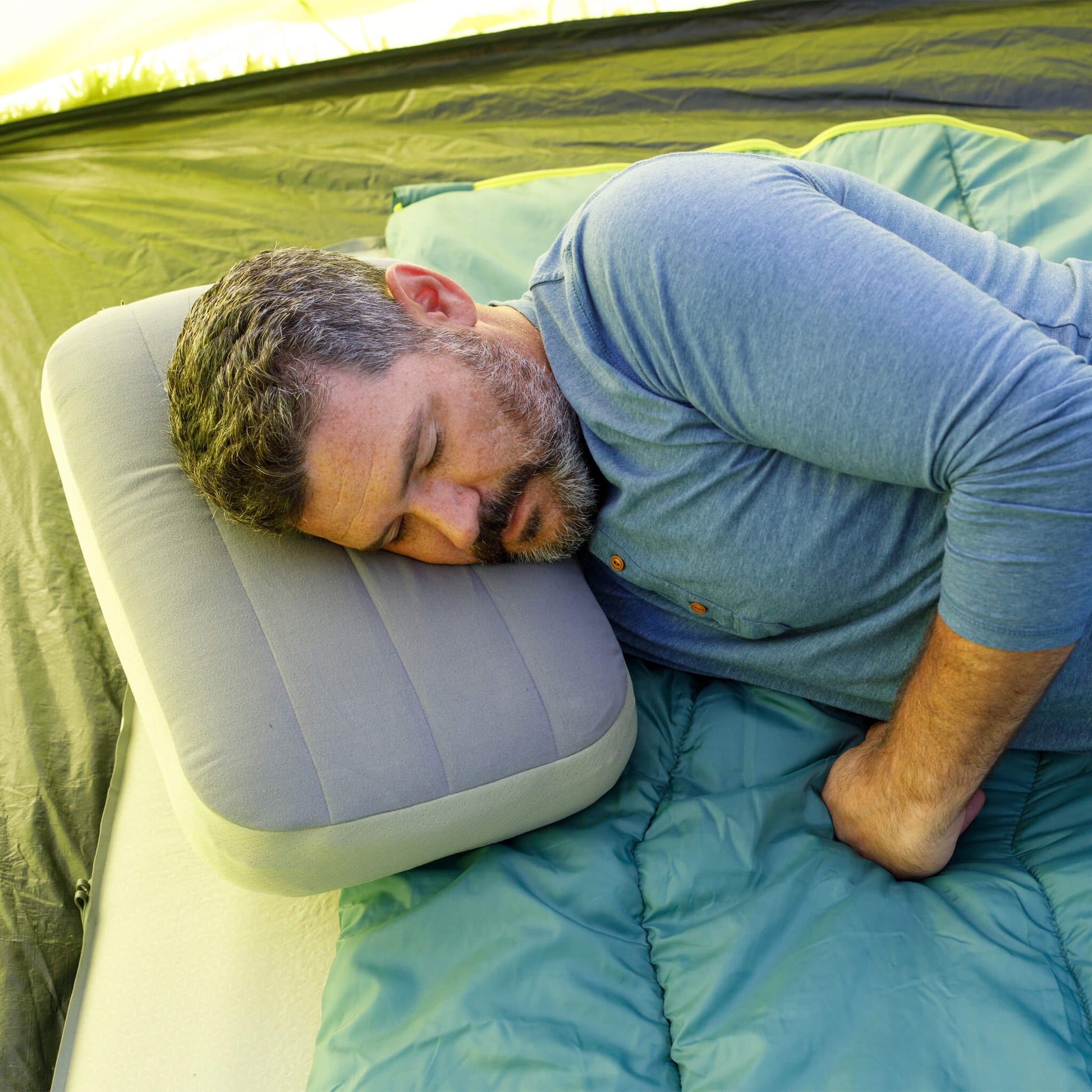 Man sleeping on a CORE double camping mattress with an inflatable. pillow