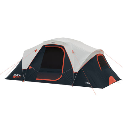 A spacious CORE 9 Person Extended Dome Blockout Tent with gray and black panels, featuring red accents. The tent has multiple mesh windows and doors, secured with red ropes and metal stakes. It's labeled "CORE" and "BLOCK OUT" on the sides.