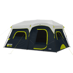 A large, black and gray camping tent with green accents. The 9 Person Instant Cabin Blockout Tent features multiple windows and a large entrance, and it is branded with “CORE” and “Block Out.” The design suggests it is spacious and suitable for group 