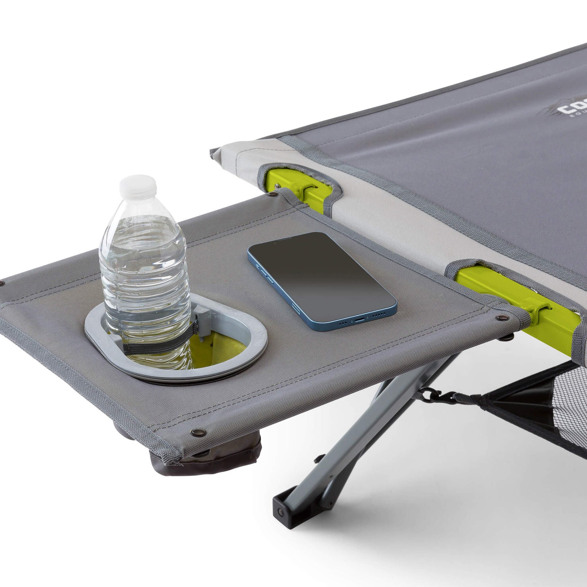 Camping side table with a water bottle and phone attached to a cot.