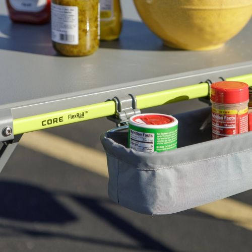 CORE FlexRail system attached to camping table with hanging storage bag holding spices and supplies, showcasing modular outdoor organization setup
