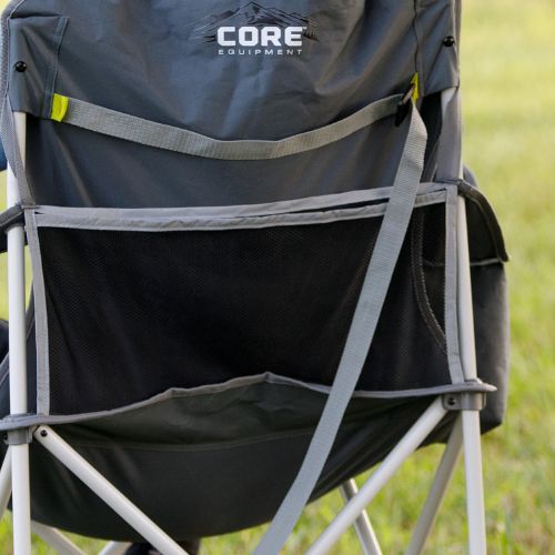 Rear view of a folding cooler quad chair featuring a large mesh storage pocket and an integrated carry strap across the back panel, with the “CORE Equipment” logo visible, set on grass outdoors.