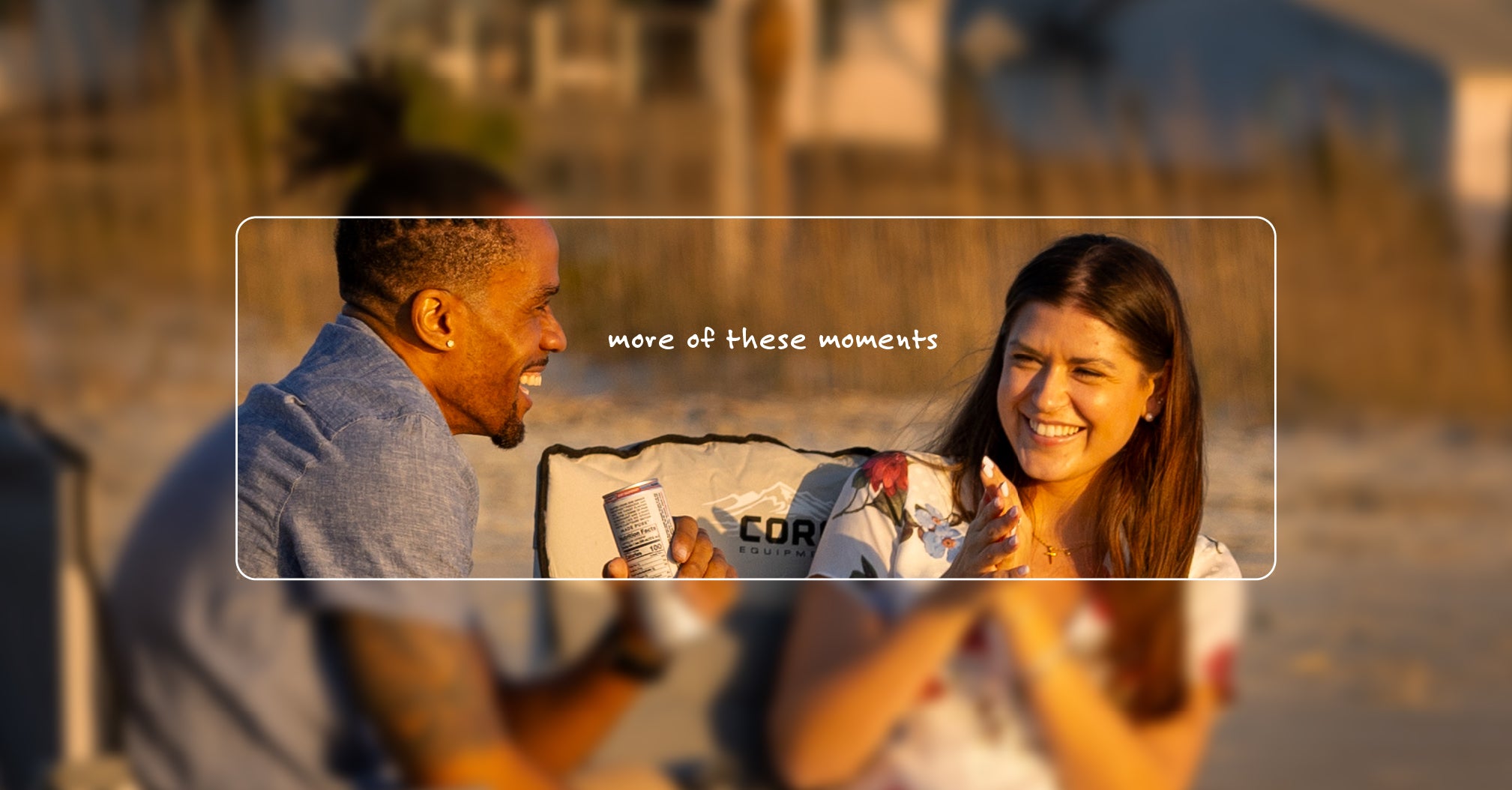 Two people sitting on a beach in CORE camp chairs with a blurred overlay text 'more of these moments'.