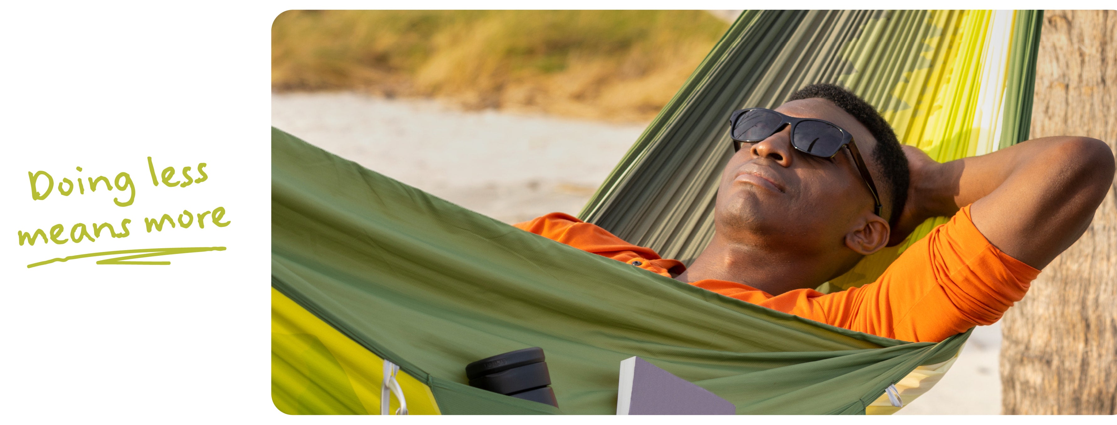 A man wearing sunglasses relaxes in a green and yellow striped hammock on a beach, with the text 'Doing less means more' on the left side.