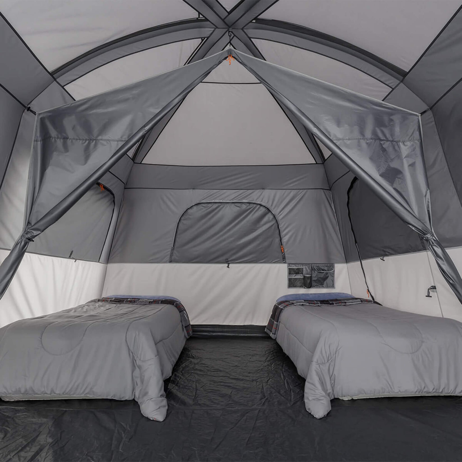 Interior of CORE 10 person straight wall cabin tent with full rainfly, showing high ceiling, divider, 2 air beds, and a spacious sleeping area.