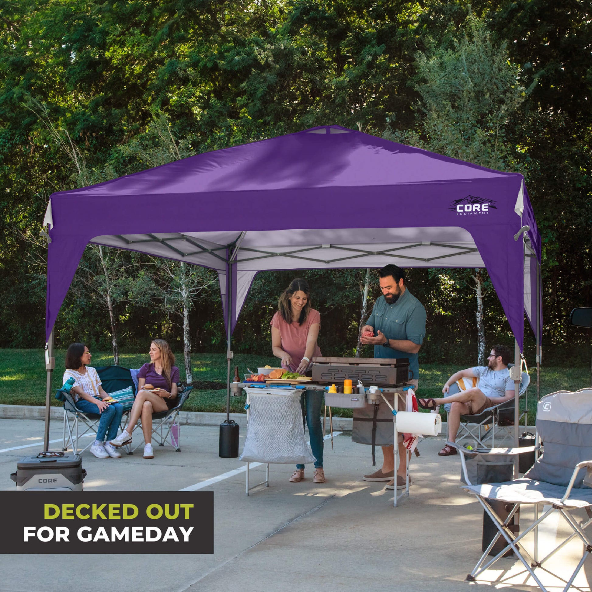 Friends relaxing outdoors under the CORE 10x10 Center Push canopy top in purple, providing shade and ventilation for gatherings.