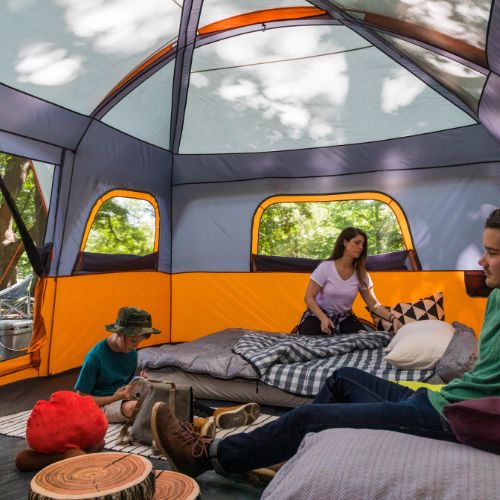 Family sitting inside CORE 12 person straight wall cabin tent.