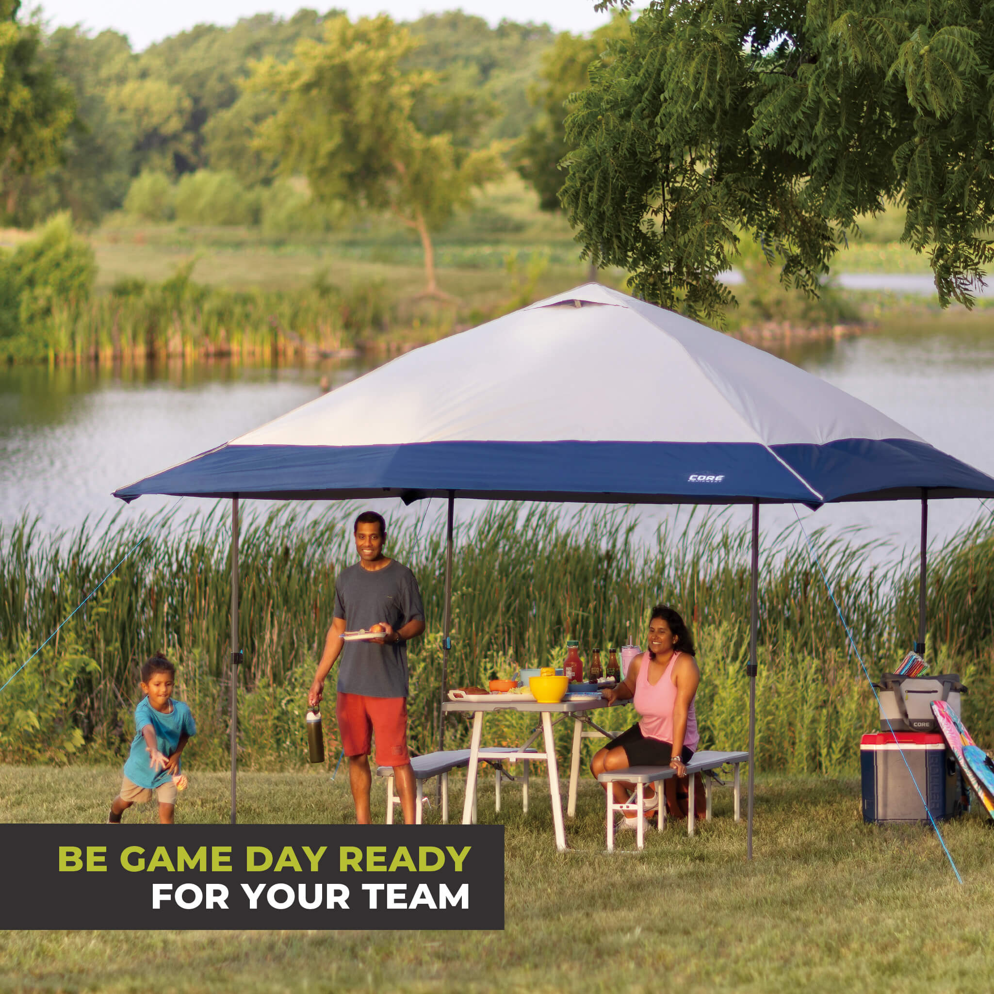 Family relaxing outdoors under the CORE 13x13 Center Push canopy top in gray/navy, providing shade and ventilation for gatherings.