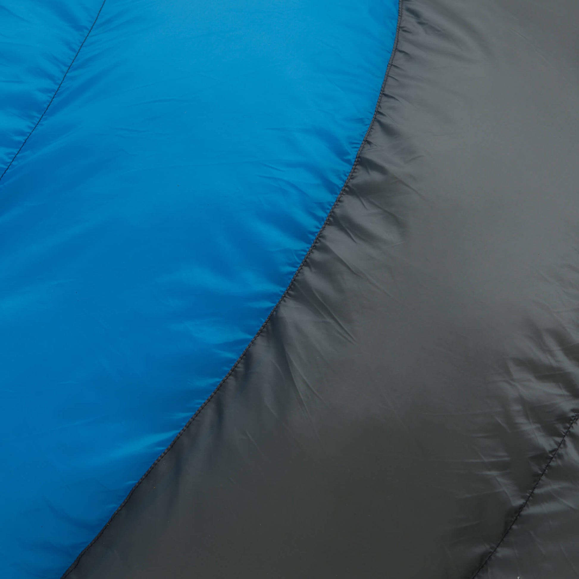 Close-up of blue and gray 30 degree sleeping bag fabric texture.