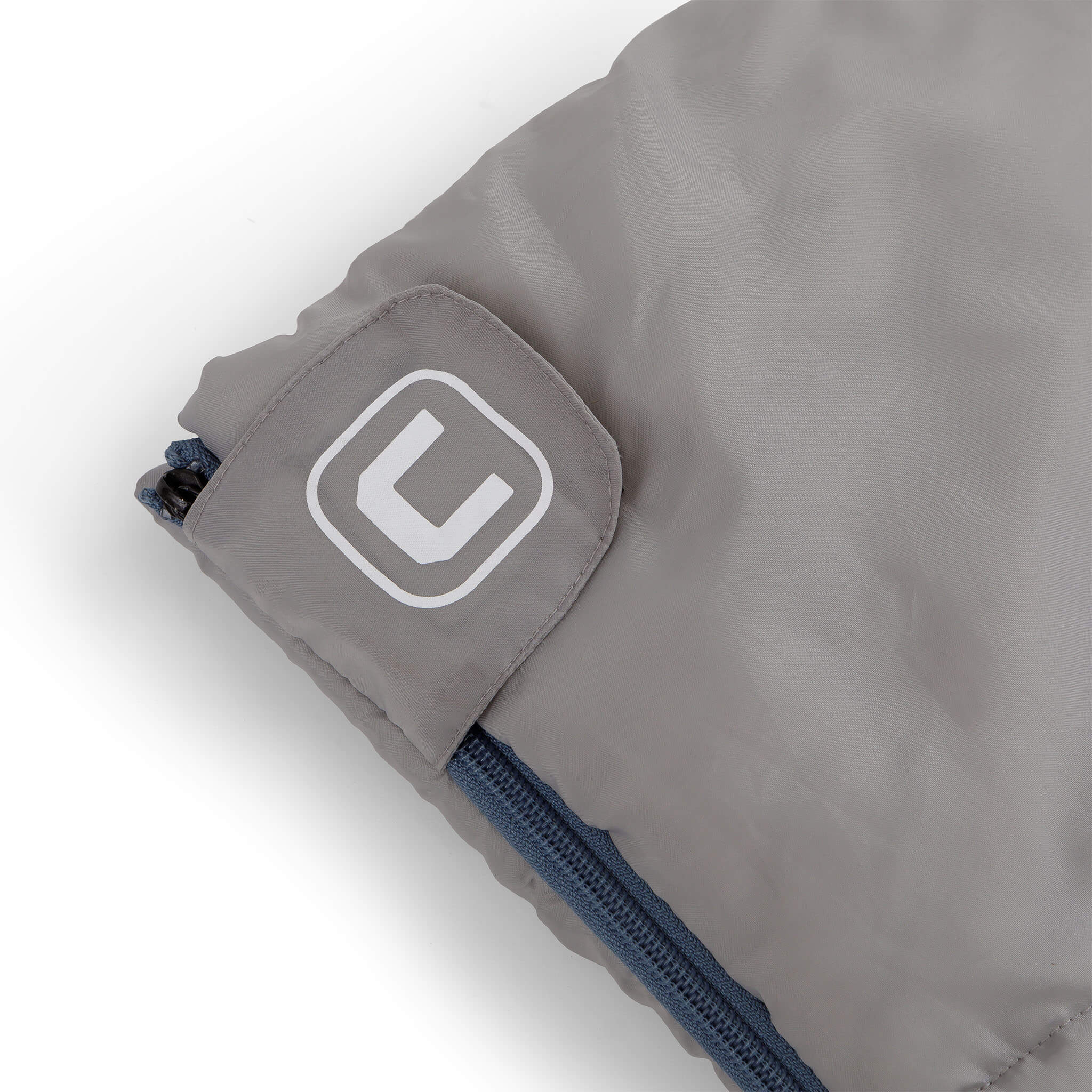 Close-up of CORE sleeping bag logo patch on zipper cuff.