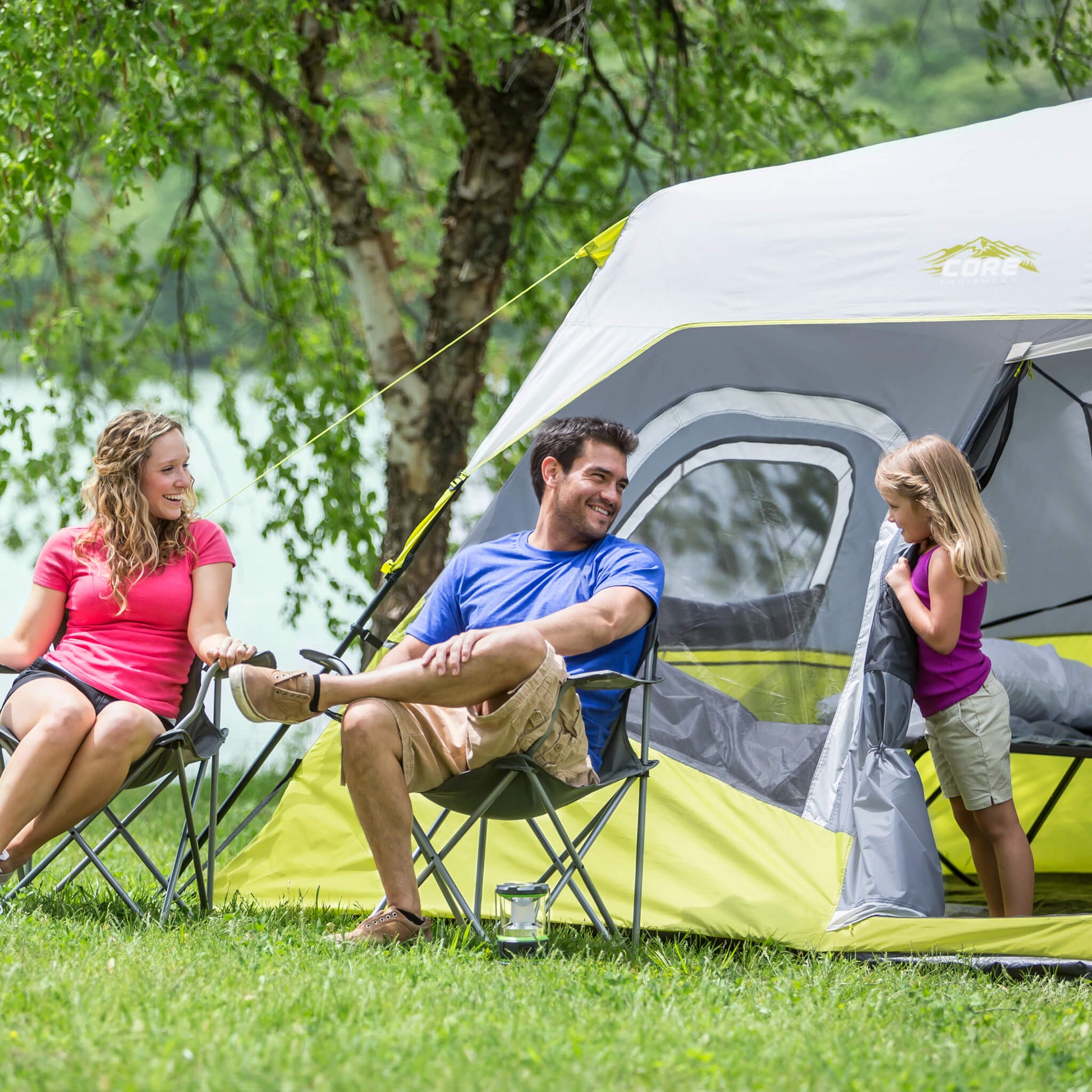 Family enjoying time outside the CORE 6 person instant cabin tent in gray and green, offering durable weather protection and comfort.