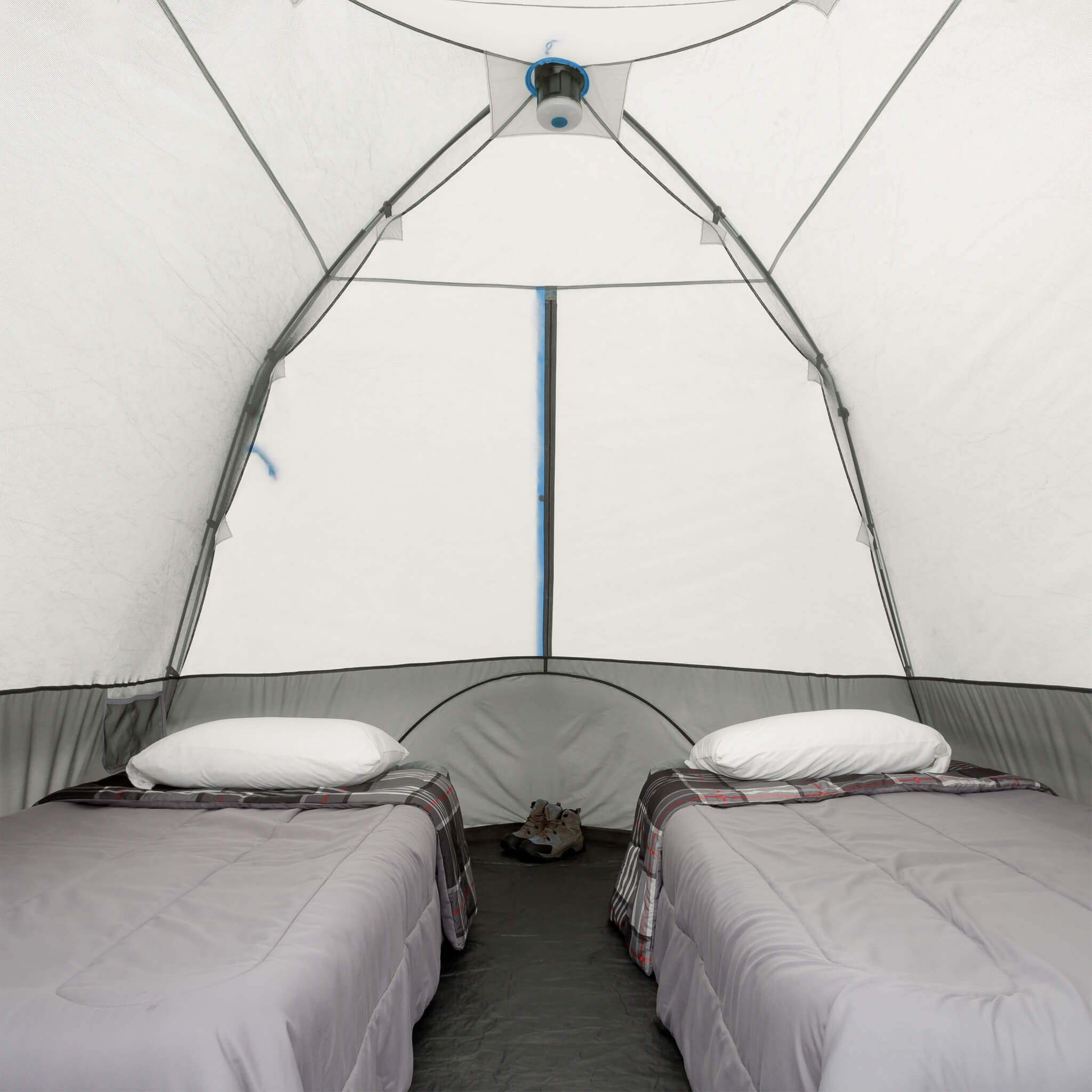 Inside CORE 6 person lighted dome tent with two cots in spacious sleeping setup.
