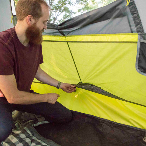 Close-up of a CORE 9 person instant tent ventilation showing durable green fabric and reinforced seams.