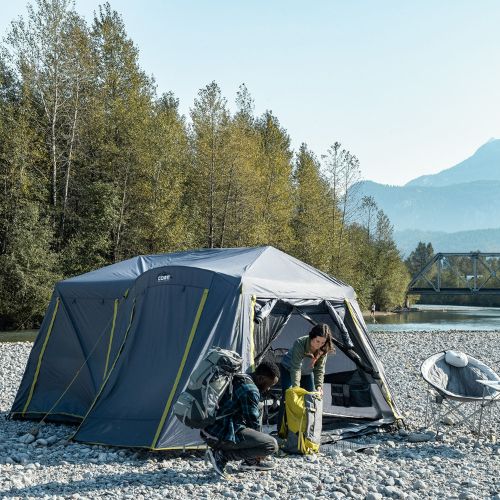 9 person instant cabin tent with full rainfly exterior lifestyle with two people standing outside of tent.