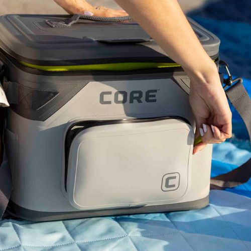A CORE 18 can soft cooler front pocket is being opened.