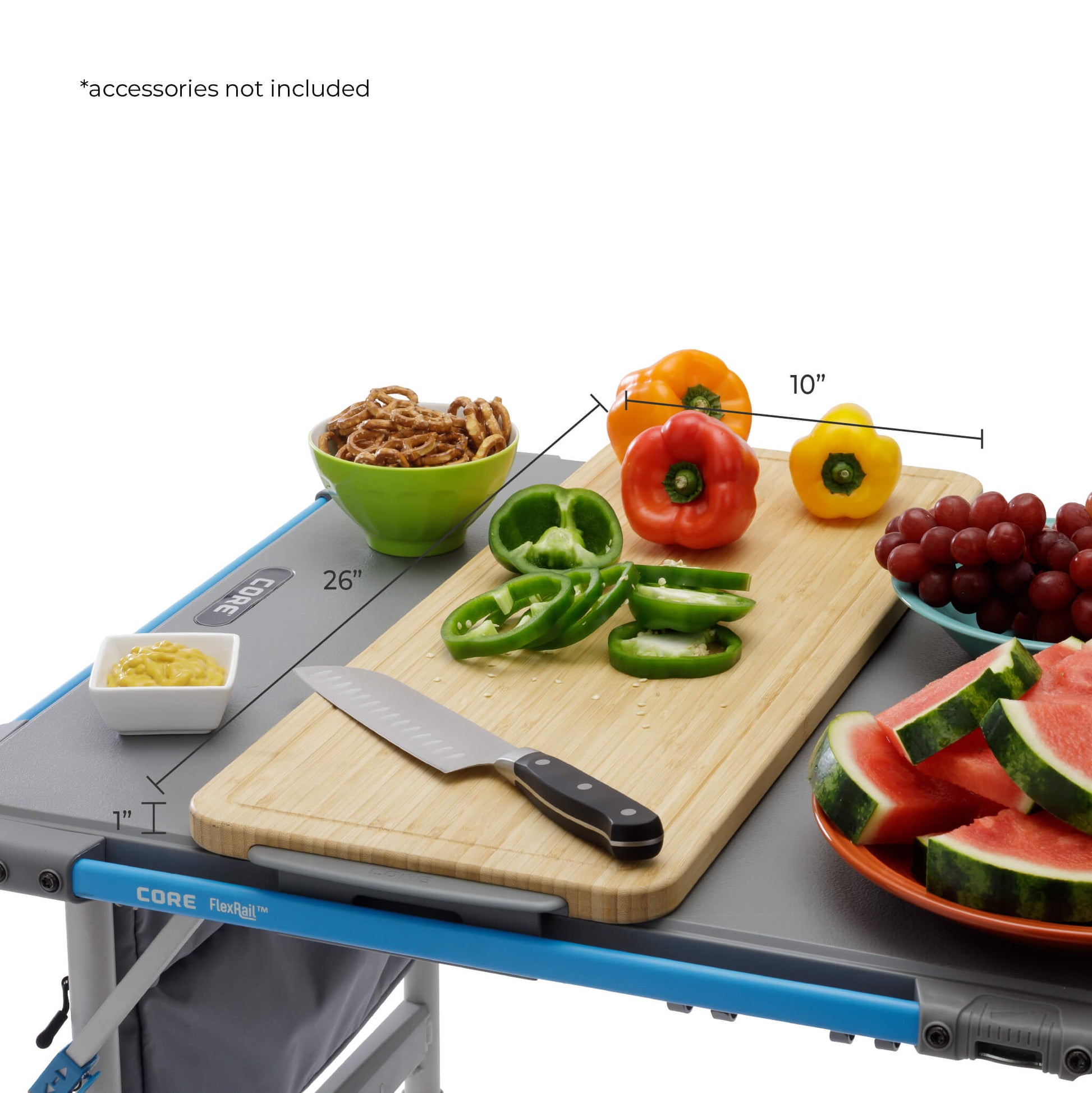CORE bamboo cutting board accessory shown on FlexRail 4 foot table with food prep, measuring 10 by 26 inches for outdoor cooking use.