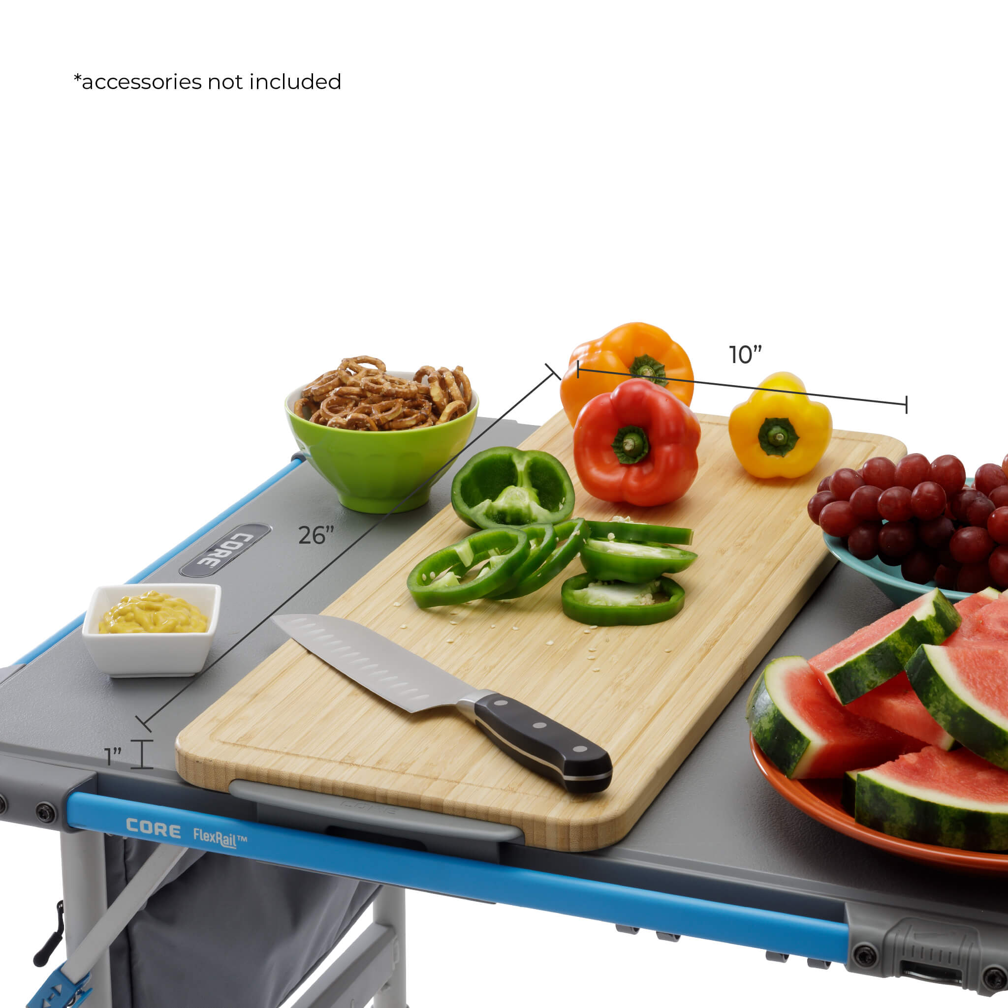 CORE bamboo cutting board accessory shown on FlexRail 4 foot table with food prep, measuring 10 by 26 inches for outdoor cooking use.