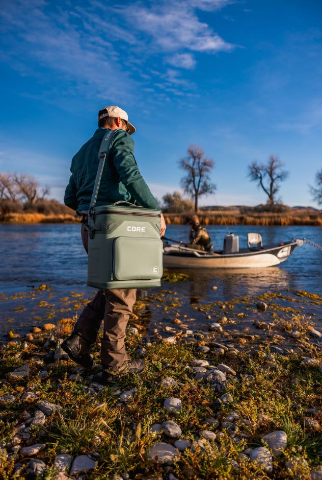 A person holding a CORE Climakeep 36 can cooler.