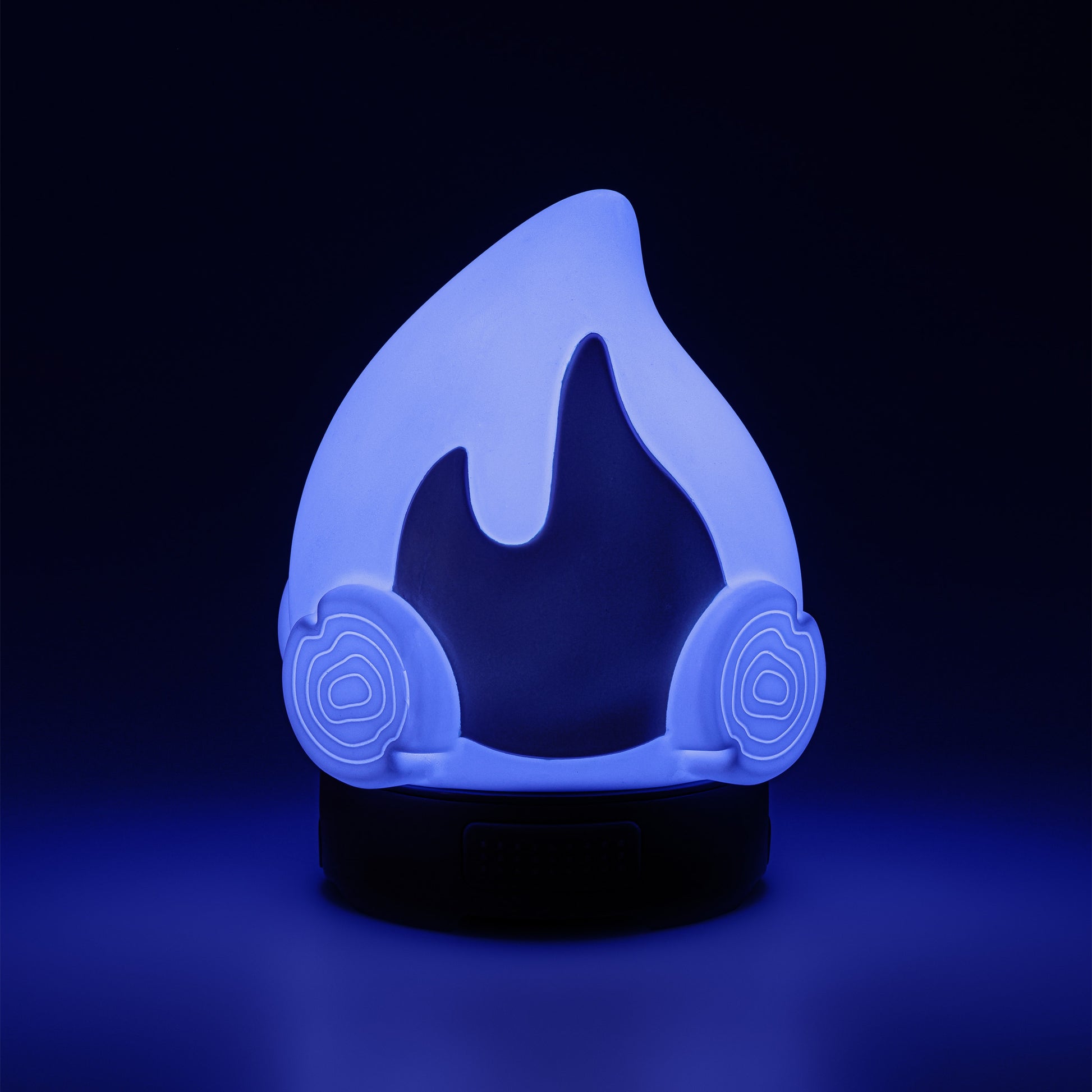 Blue flame-shaped night light on a black background.
