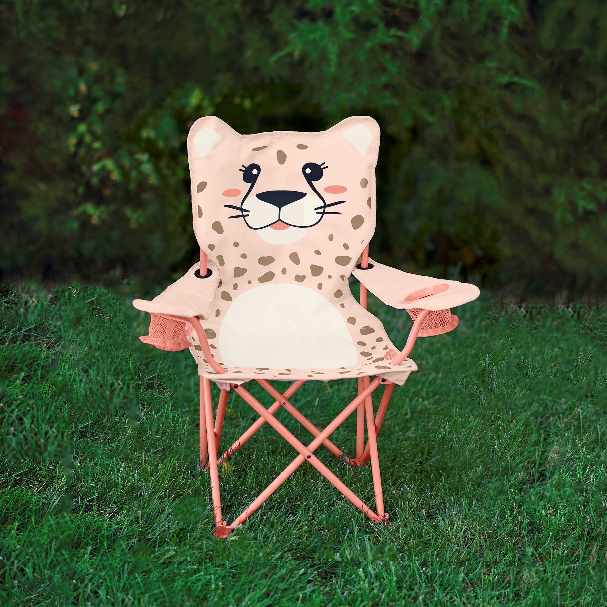 Pink kids' folding camping chair with a smiling cheetah face and spotted print, featuring two mesh cup holders and a durable steel frame, sitting in the grass.