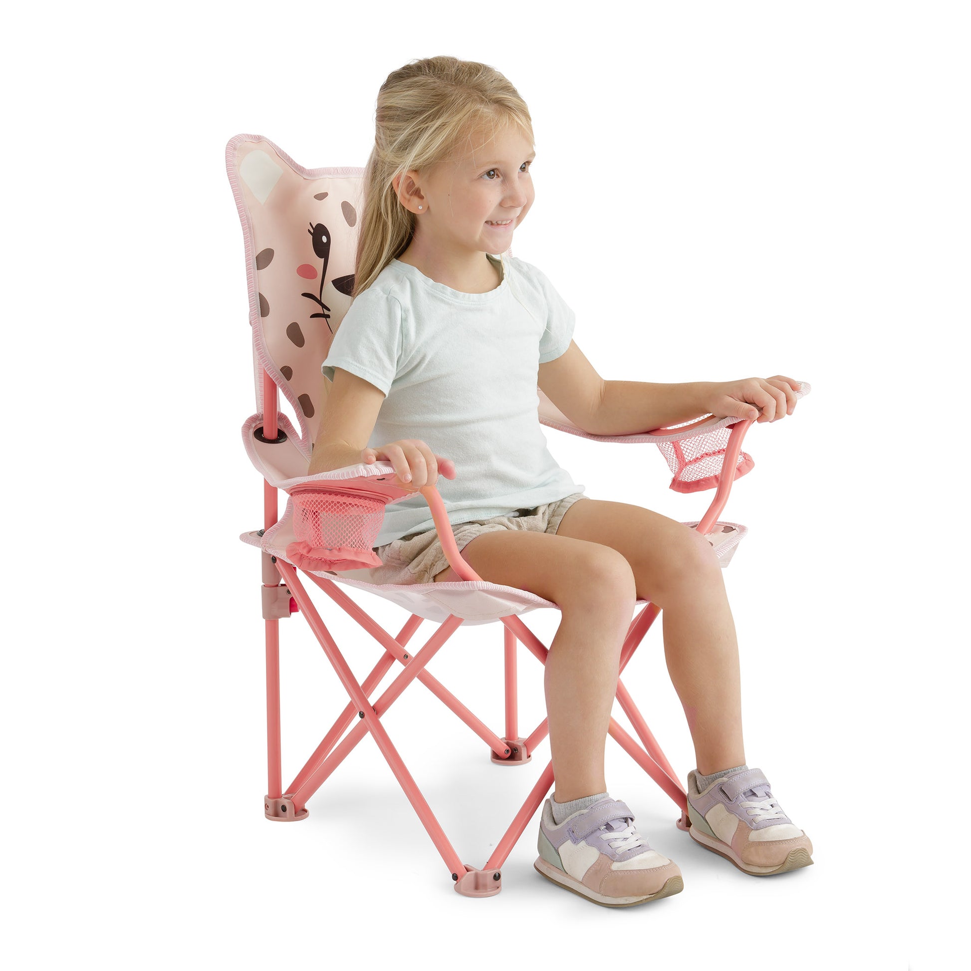 Young child sitting comfortably in the pink kids' cheetah camping chair, showing its child-sized fit, supportive design, and dual mesh cup holders.