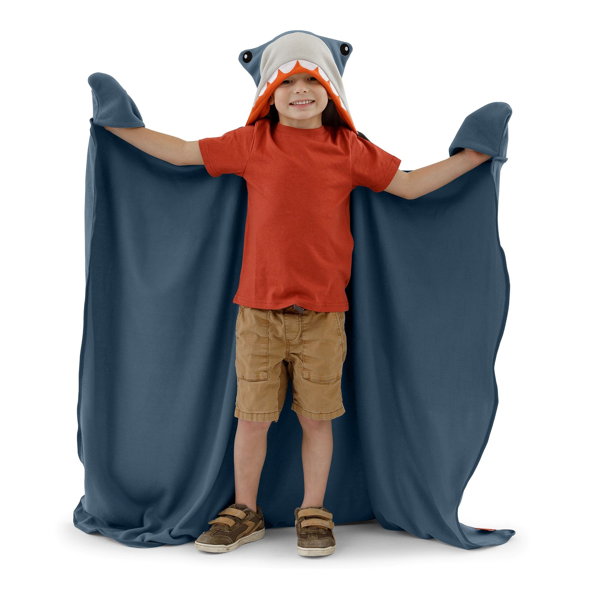 A child wearing a shark blanket on a white background.