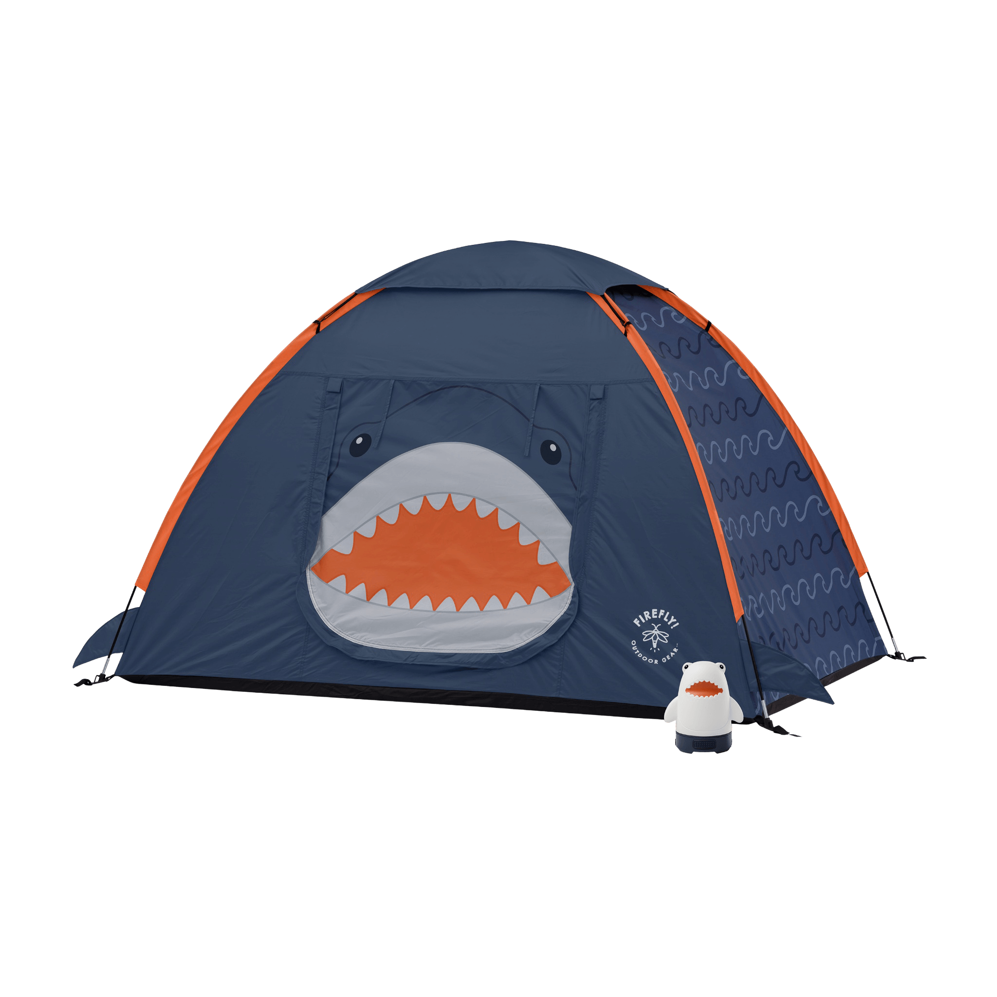 A navy blue dome tent with orange trim, featuring a shark face graphic on the front door and a small white-and-orange shark-shaped accessory lantern placed beside it.