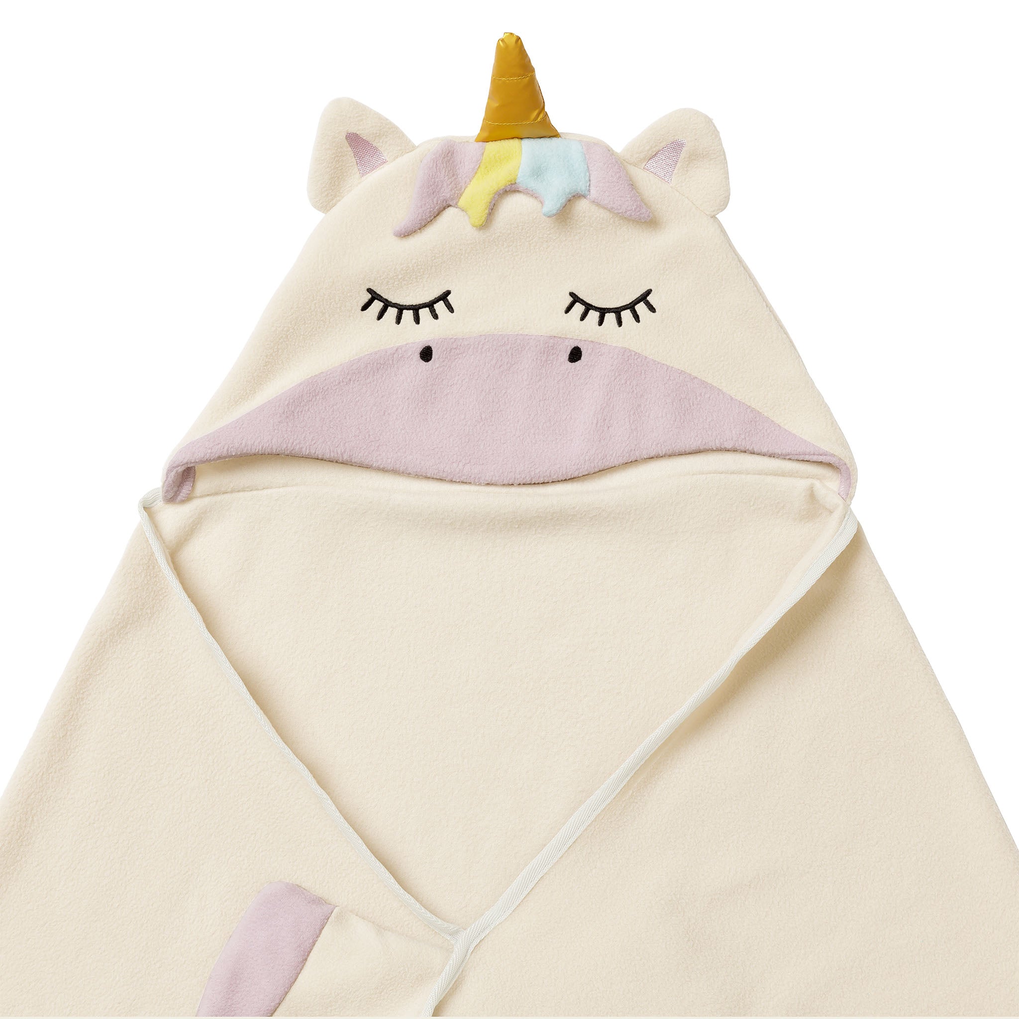 Close-up of a unicorn-themed blanket, partially folded. 