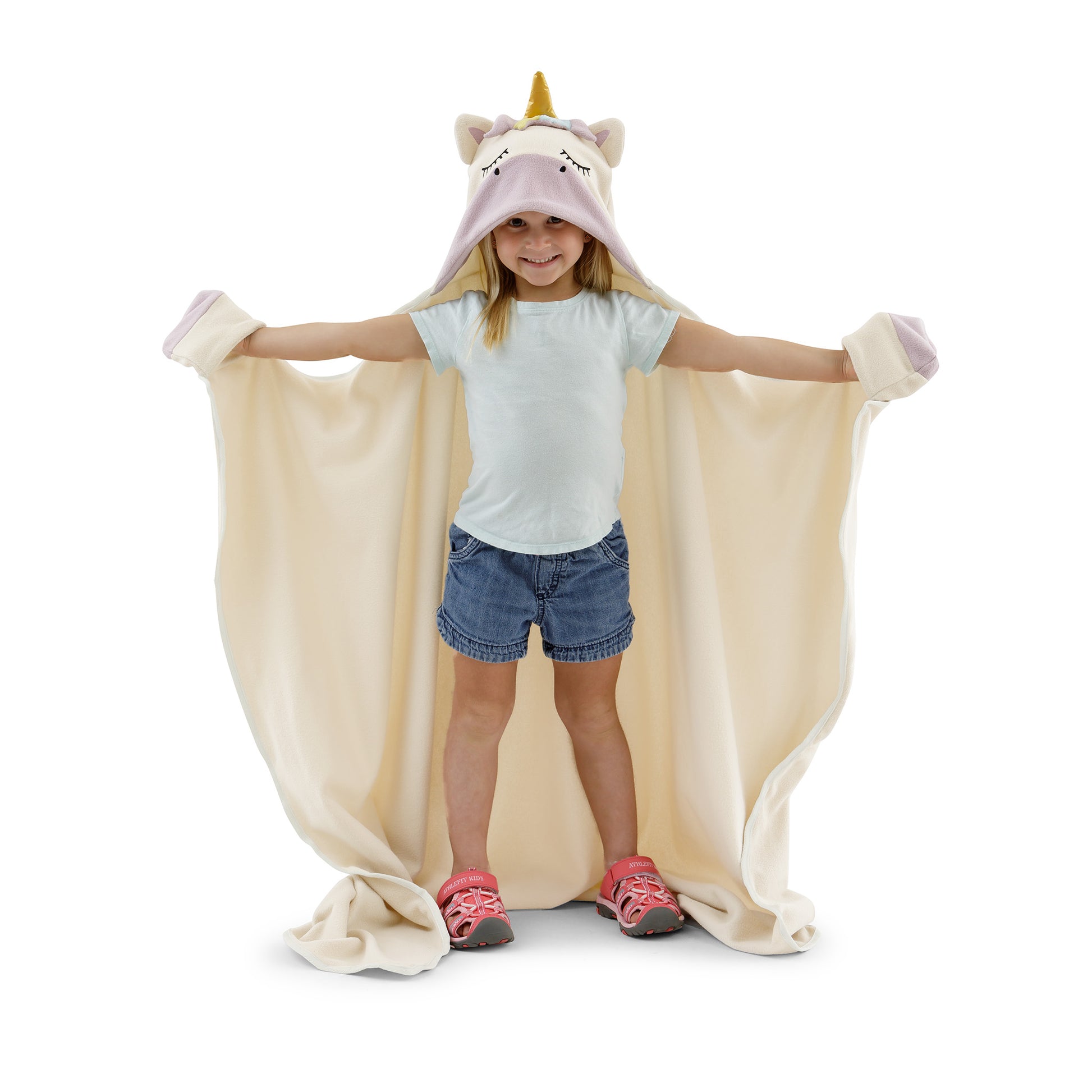 A child wearing a unicorn blanket on a white background.