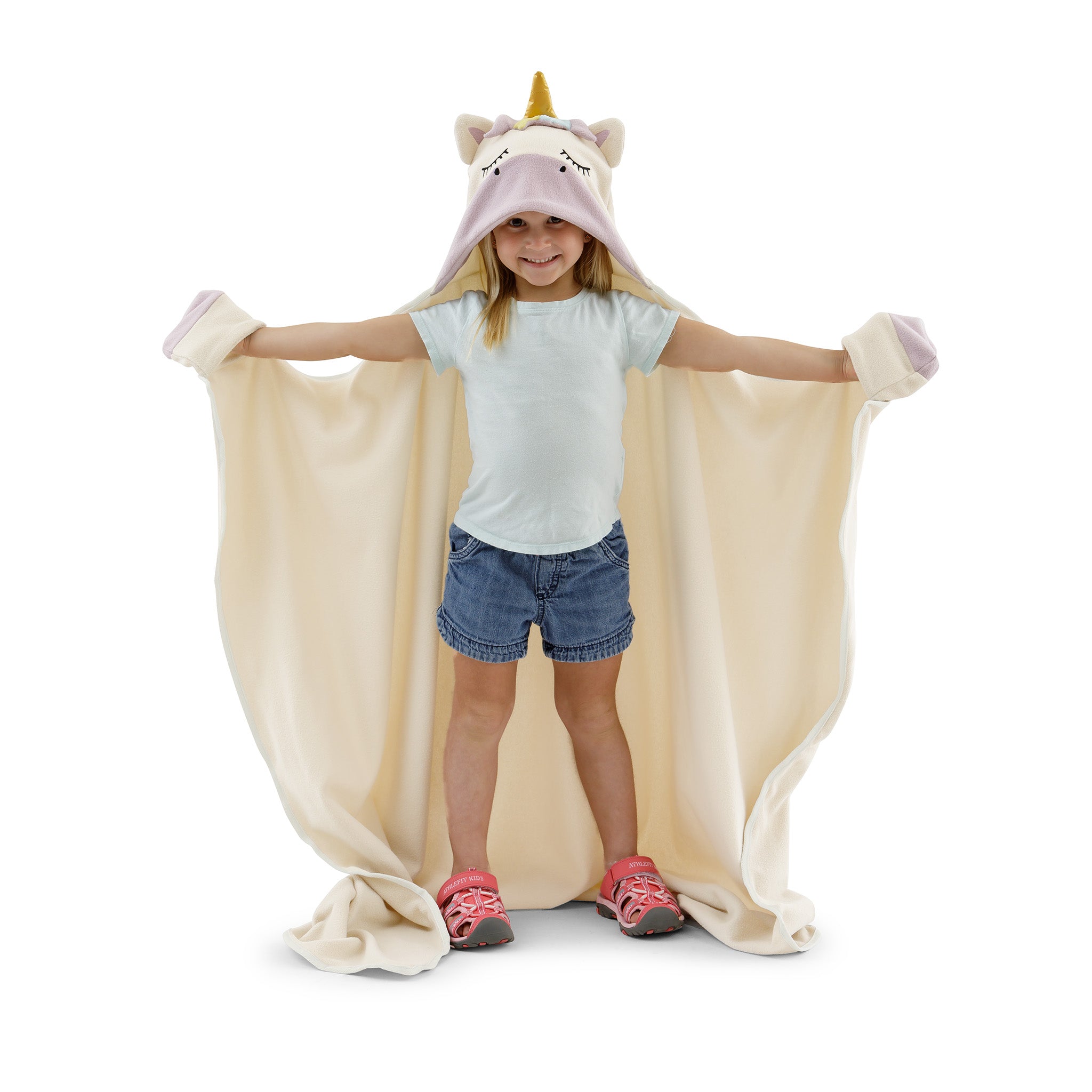 A child wearing a unicorn blanket on a white background.