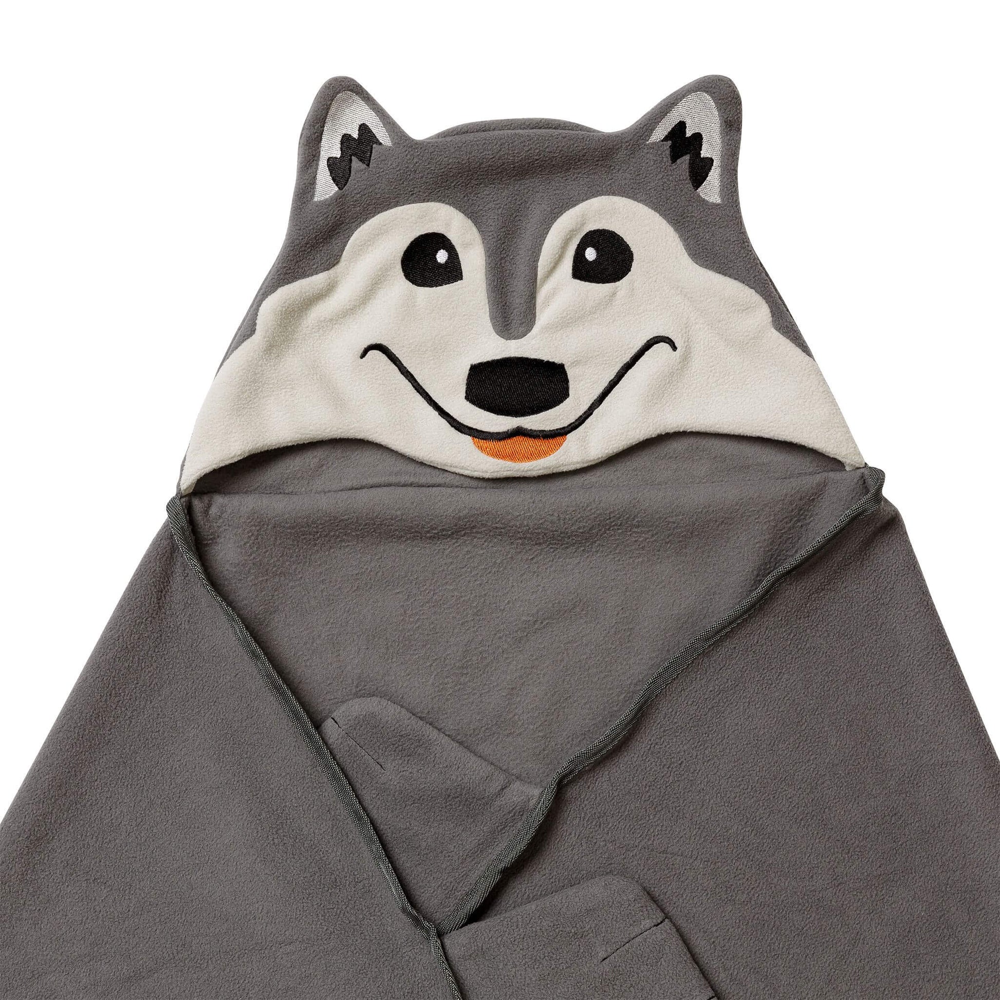 Close-up of a wolf-themed blanket, partially folded. 