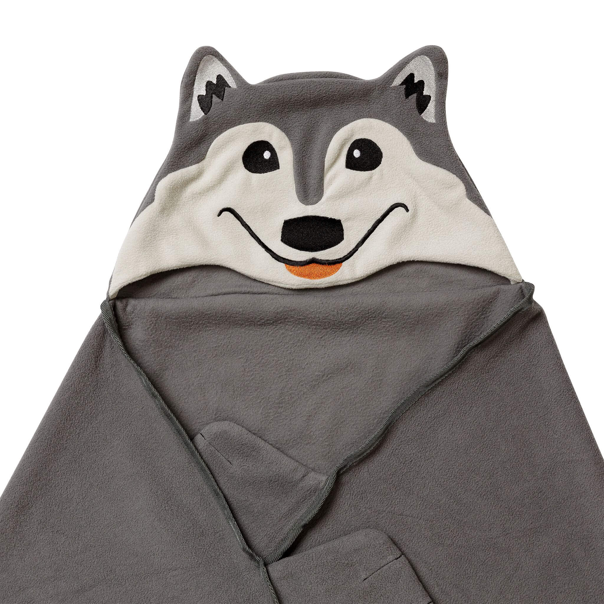 Close-up of a wolf-themed blanket, partially folded. 