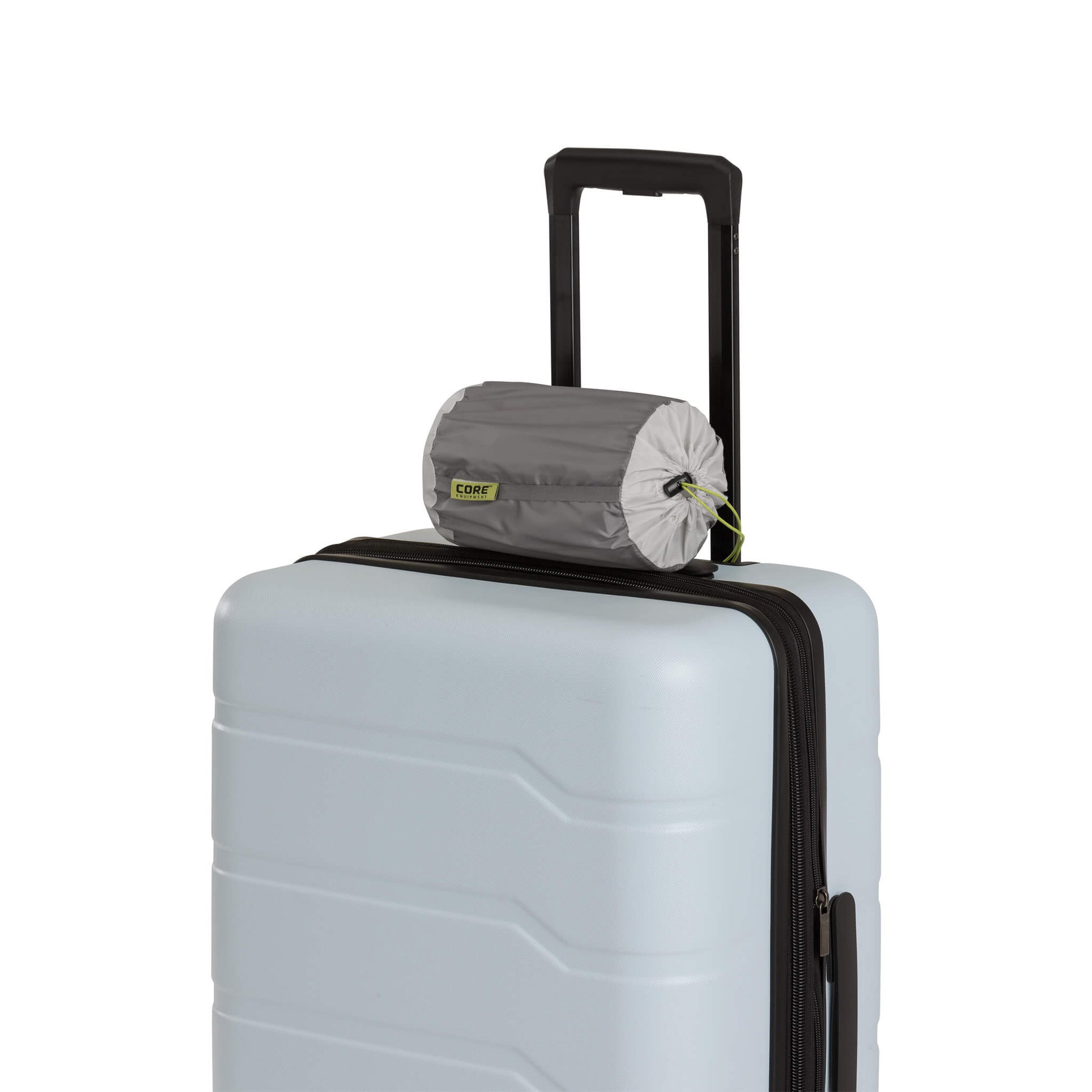 CORE inflatable hybrid pillow rolled and attached to the suitcase handle.