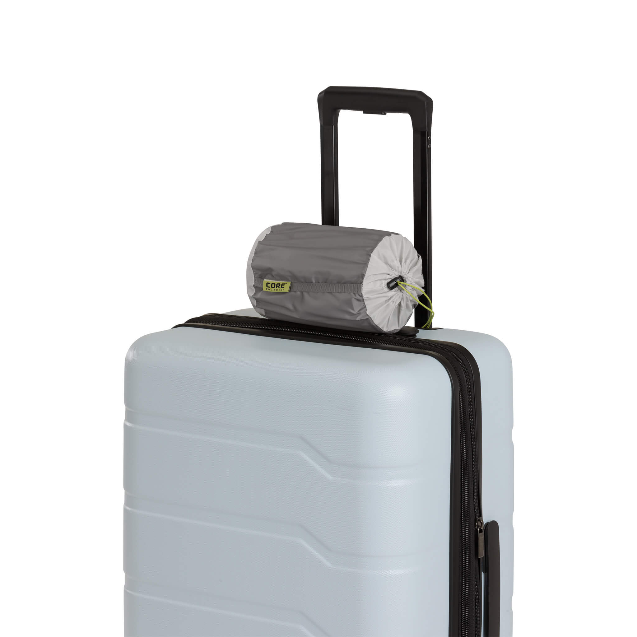 CORE inflatable hybrid pillow rolled and attached to the suitcase handle.
