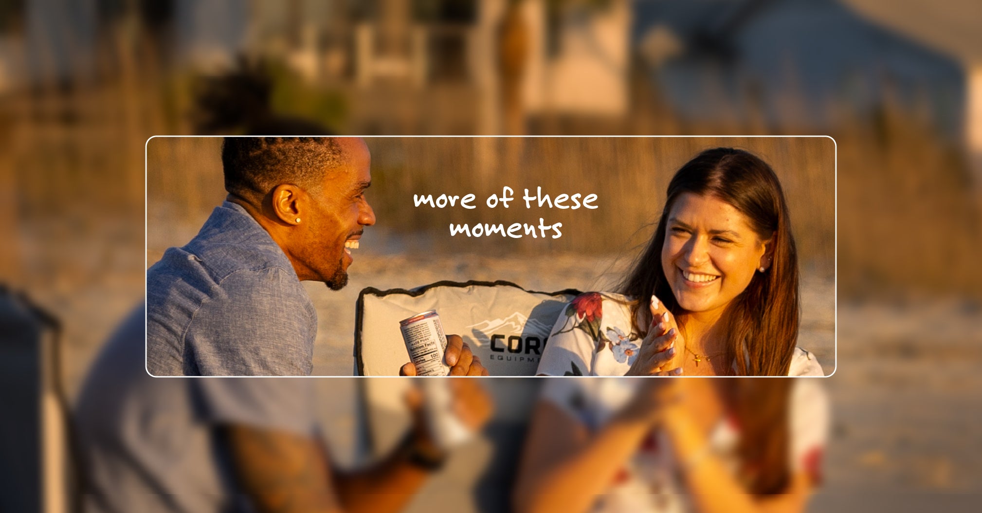 Two people sitting on a beach with a blurred overlay text 'more of these moments'.