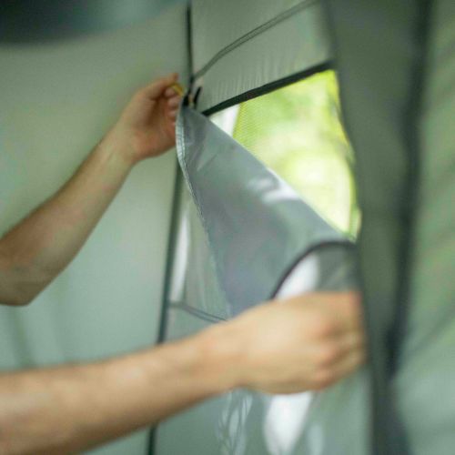 A person is adjusting the window shade on a CORE instant shower ternt.